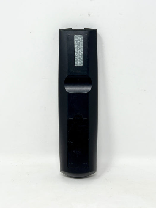 A black plastic remote control standing vertically against a plain white background.