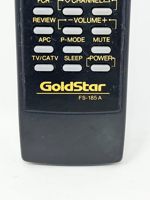 A close-up of a GoldStar FS-185 A remote control showing the top button panel with yellow labels on a black plastic body, set against a plain white background.