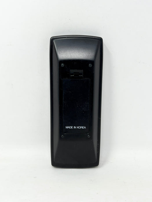 The back of a black plastic remote control with a battery compartment, featuring the text 'MADE IN KOREA' in white, set against a plain white background.