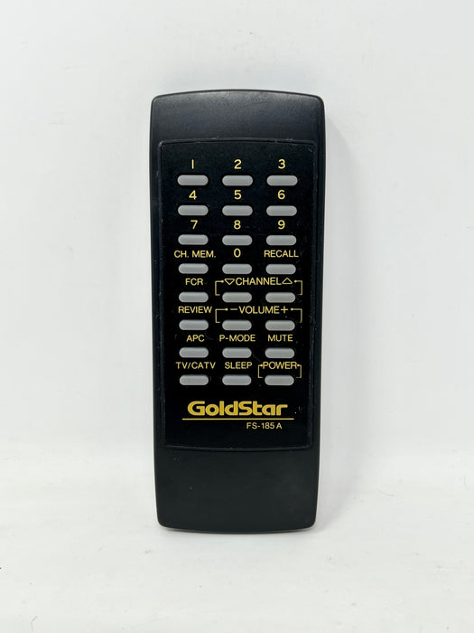 A black GoldStar remote control with yellow text and white buttons, photographed against a plain white background.