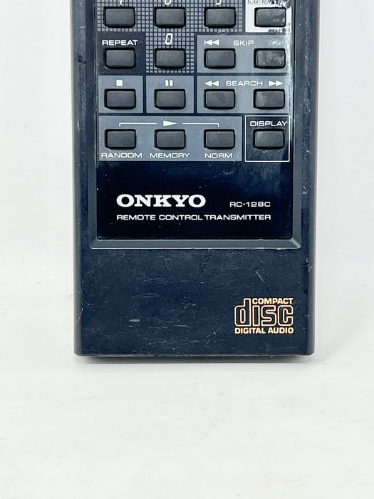 An Onkyo RC-128 remote control transmitter for compact disc digital audio, featuring a black plastic body with a gray button panel and white branding.