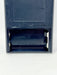 Close-up of the bottom section of a dark blue plastic device showing a battery compartment with a single battery installed and 'MADE IN JAPAN' embossed on the side.