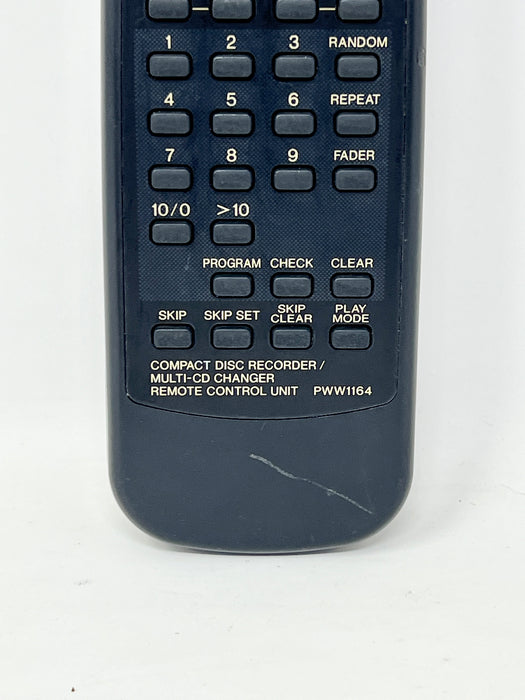 A dark blue compact disc recorder remote control unit with a numeric keypad and white text labels on a white background.
