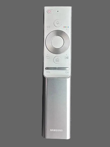 Samsung remote control on a gray textured surface