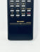A close-up of a dark blue Sharp TV remote control showing the number pad and buttons including CH, VOL, MUTE, POWER, and FLASHBACK on a white background.