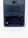 Close-up of the back of a black plastic battery-operated device with the battery compartment cover removed, showing spring-loaded contacts and embossed text including 'MADE IN JAPAN'.
