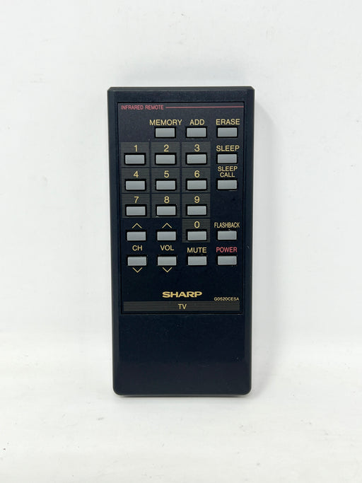 A black Sharp KD-O90CE4A infrared TV remote control with a gold and gray button layout, photographed against a plain white background.
