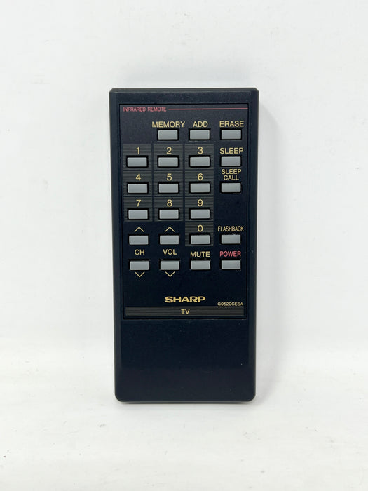 A black Sharp KD-O90CE4A infrared TV remote control with a gold and gray button layout, photographed against a plain white background.