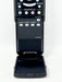 A black remote control device with its front cover open, showing buttons and labels such as EXIT, RETURN, FAVORITE CH, SLEEP, AUDIO, AV MODE, and CC, photographed against a plain white background.