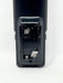 Close-up of the battery compartment cover of a black electronic device, showing the interior battery slots and terminals on a white background.
