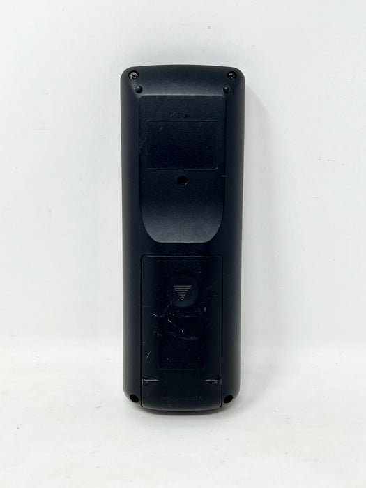 The back of a black remote control with screw terminals and a recessed area, photographed against a plain white background.