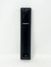 A tall, narrow black electronic device with ribbed sides and a circular dial, photographed upright against a plain white background.