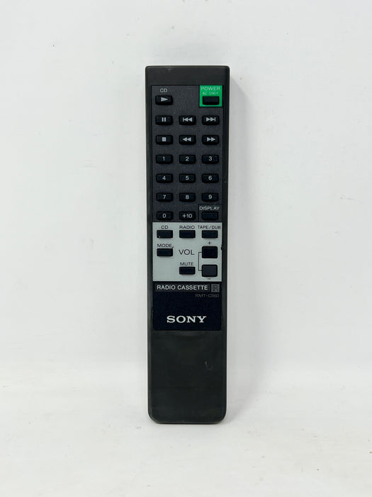 A black Sony Radio Cassette remote control standing upright against a plain white background.