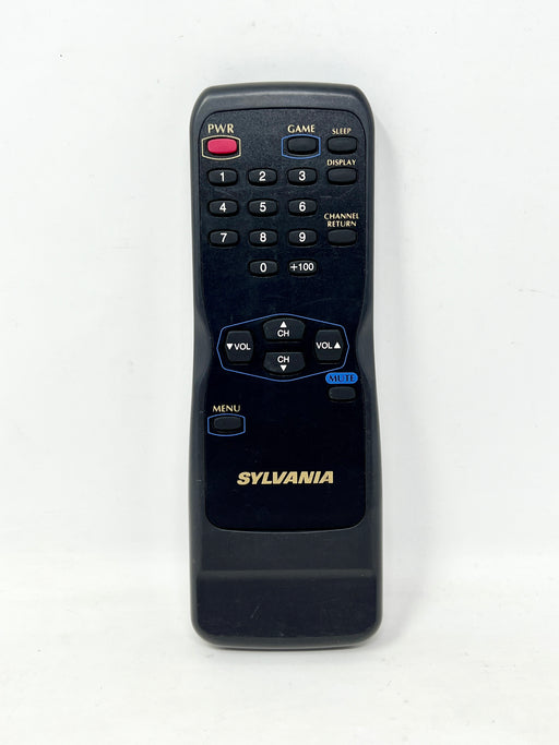 A black Sylvania remote control with gold lettering and blue and red button accents, photographed against a plain white background.