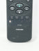 A close-up of a Toshiba remote control, model CT-9753, showing the front buttons including PLAY/x2,REW, STOP, FF, EXIT, MENU, and PROG.