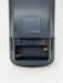 Close-up of the back of a black remote control showing the battery compartment with two AAA batteries inserted, on a white background.